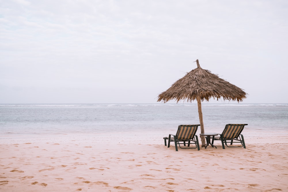 two brown armchairs on brown sand