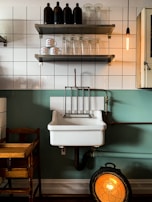Under-sink view showing neat, organized plumbing pipes and connections in a cozy kitchen.