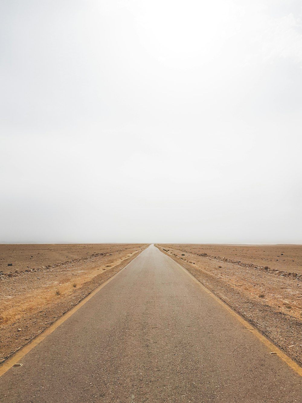 empty road under grey sky
