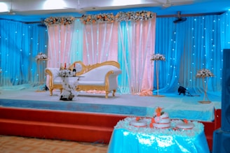 sofa on stage with blue curtains