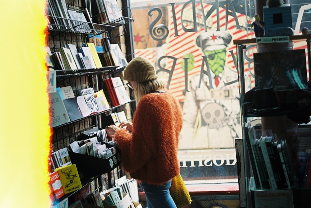 woman standing beside shelf