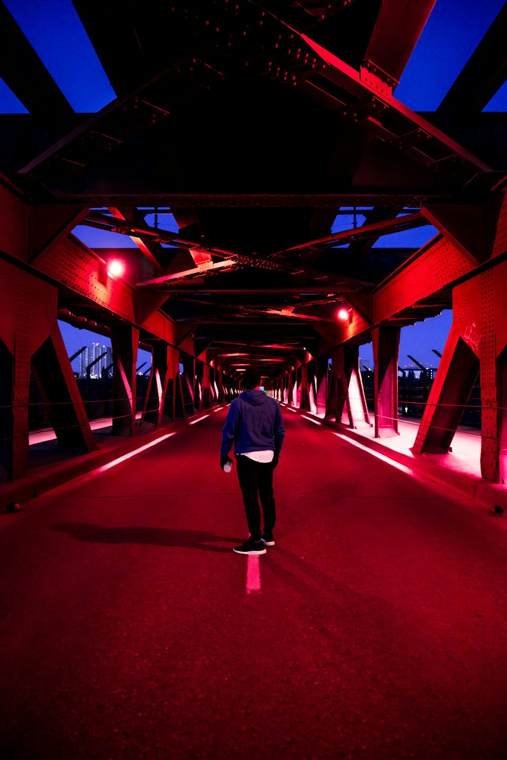 man standing beside paved road