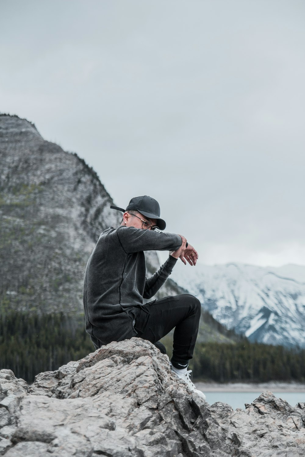 man sitting on rock