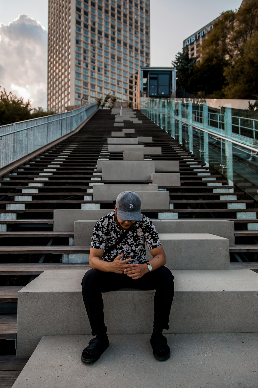 sitting man wearing gray cap during daytime