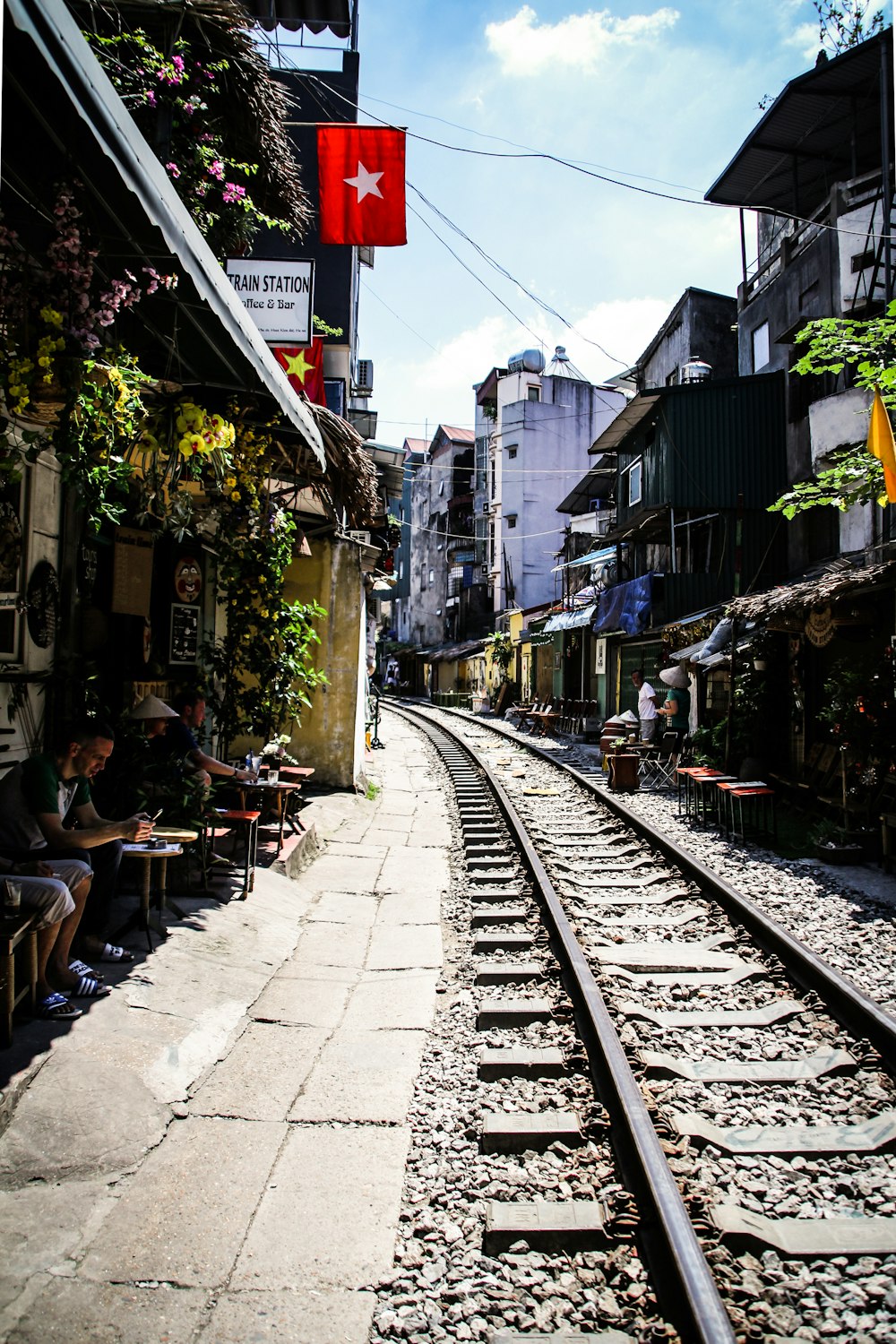 gray train railway between houses during daytime