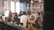 A diverse group of professionals discussing renewable energy solutions in a modern office setting.