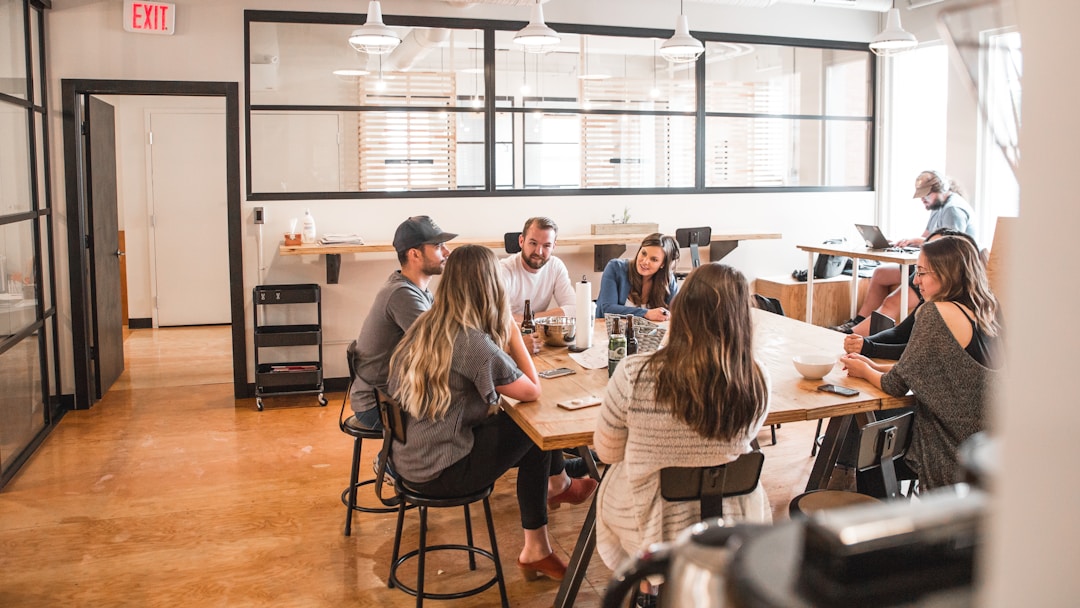 Business meeting where six employees discuss relationship mapping software