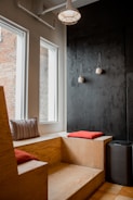 empty brown wooden bench under white lamp