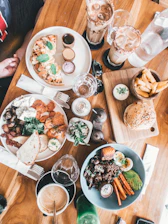plates and bowl of foods on brown wooden table