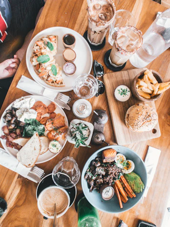 plates and bowl of foods on brown wooden table
