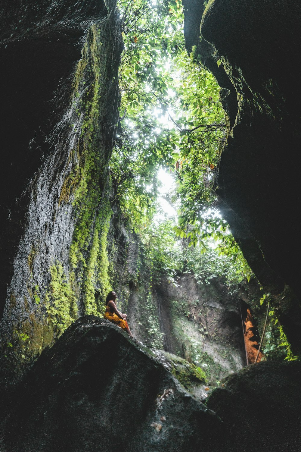 woman sitting on the stone near the tunnel