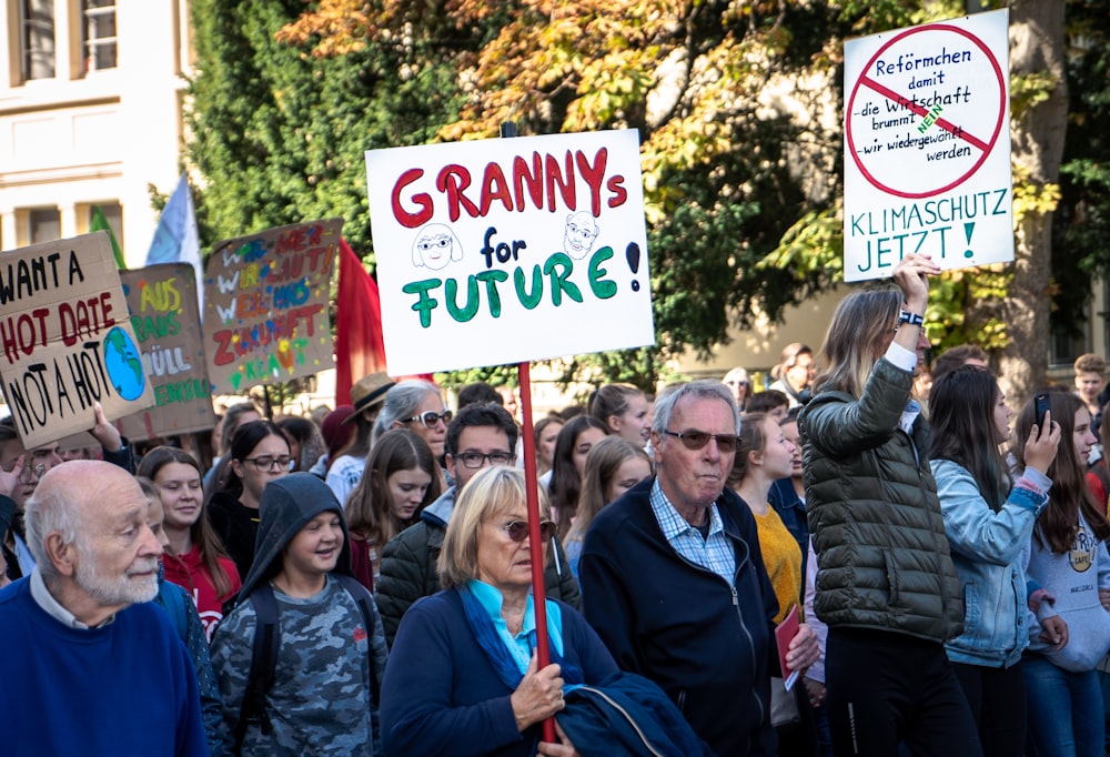 people holding signs during day