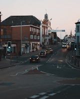 cars on road near houses