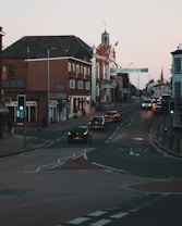 cars on road near houses
