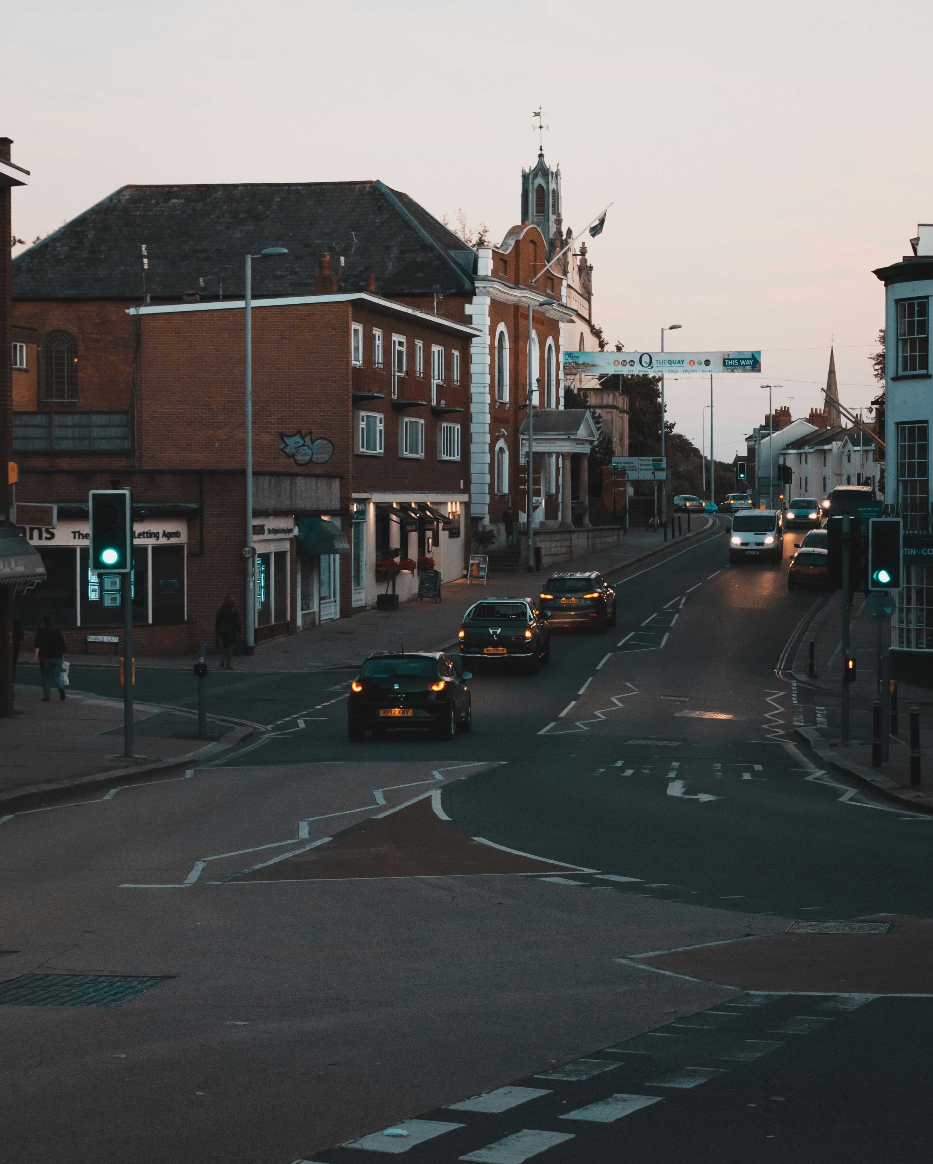 cars on road near houses