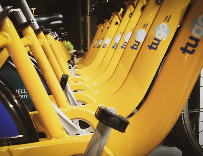 line of parked yellow Tugo bikes