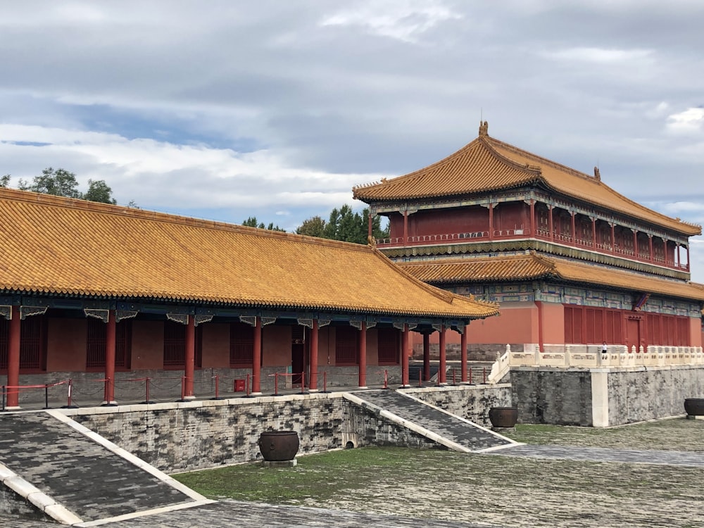 brown and red pagoda house under white clouds