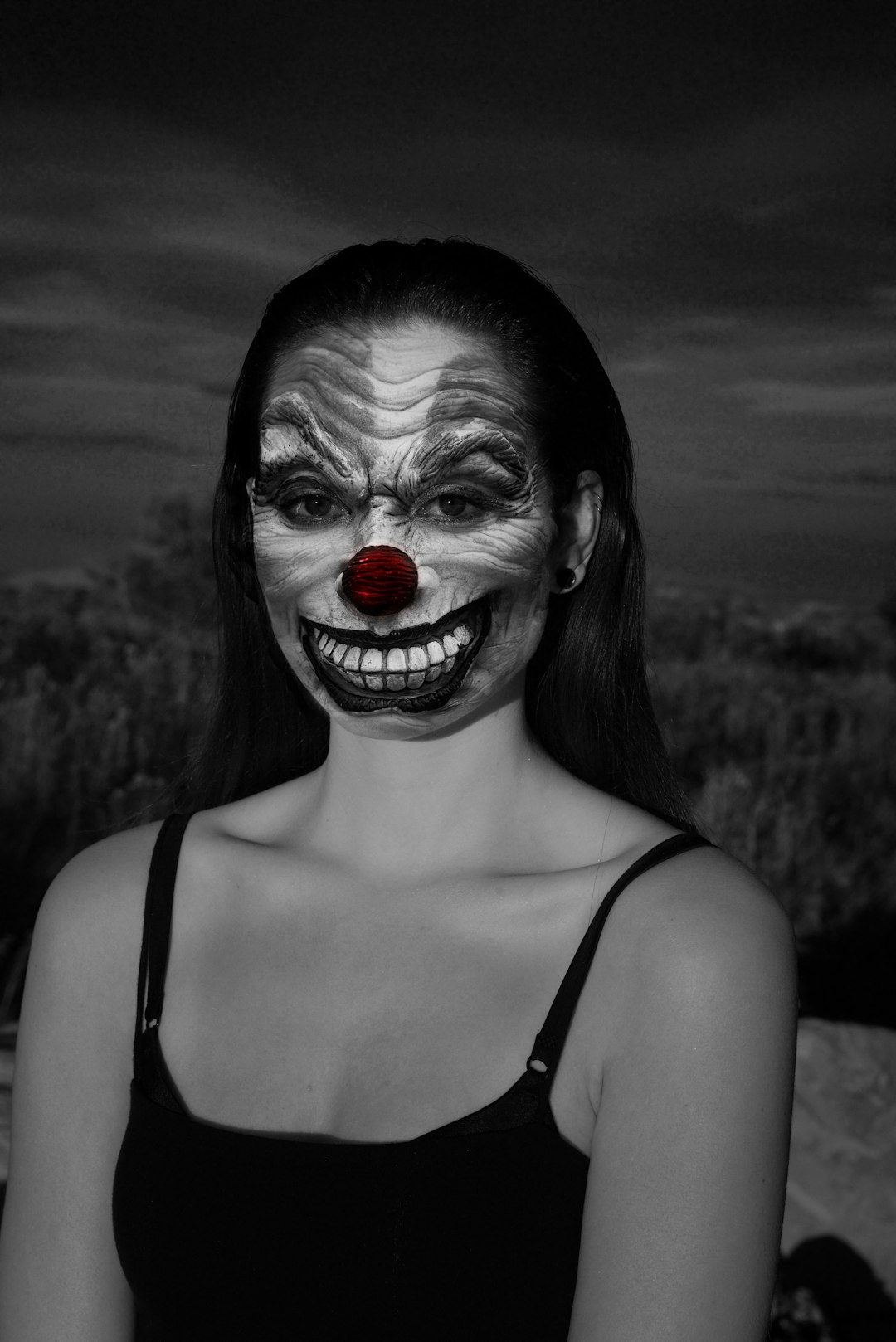 woman wearing spaghetti strap top with clown face