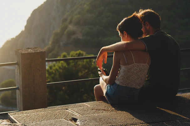 A cozy couple enjoying a sunset view over Kotor Bay from a scenic hilltop