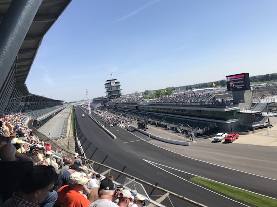 Photo of crowded grandstand sector G with enthusiastic Formula 1 fans during a race.