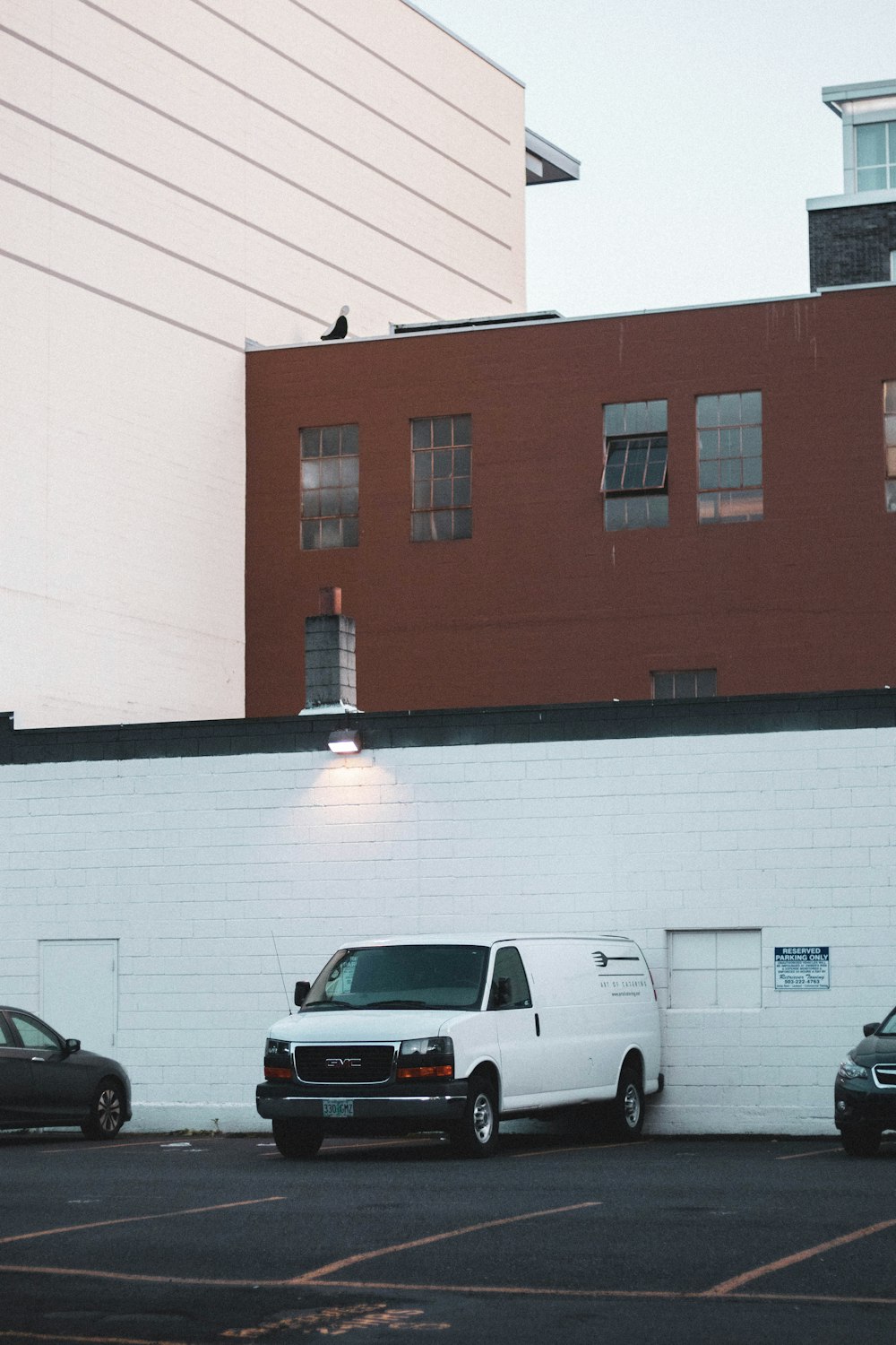 white van beside wall