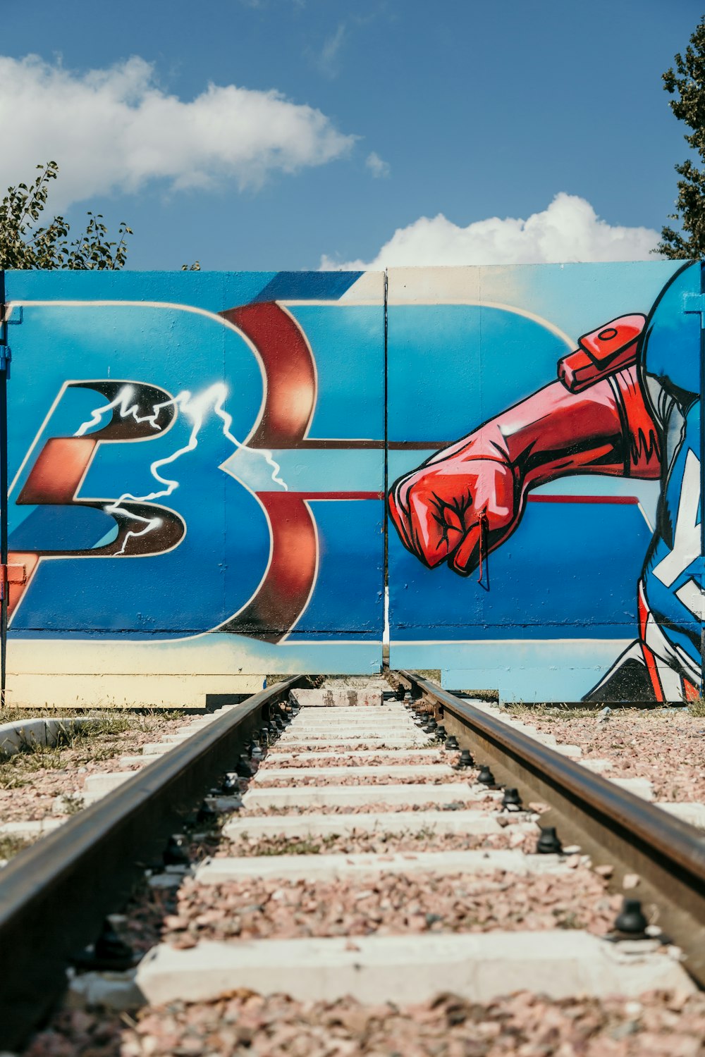 a train track with graffiti on the side of it