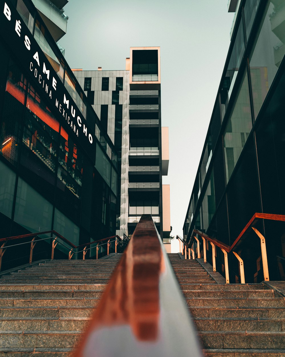 low-angle photography concrete stairs near high-rise buildings during daytime