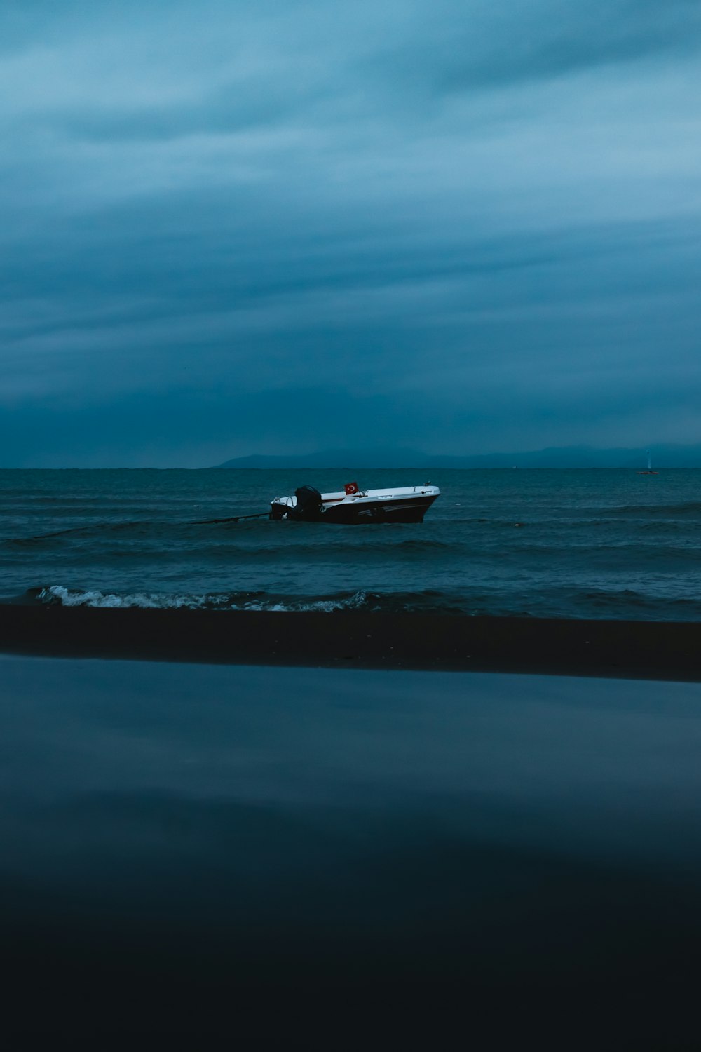 a boat floating on top of a large body of water