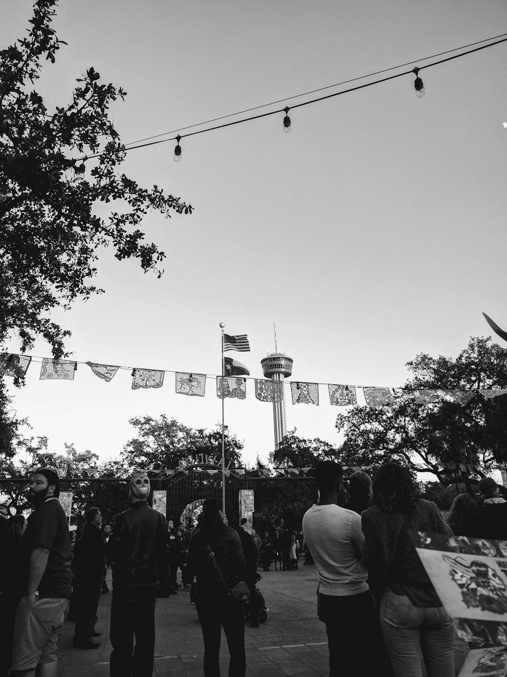 grayscale photo of people near tree