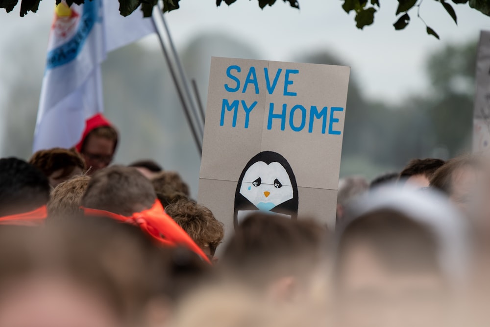 shallow focus photo of save my home signage