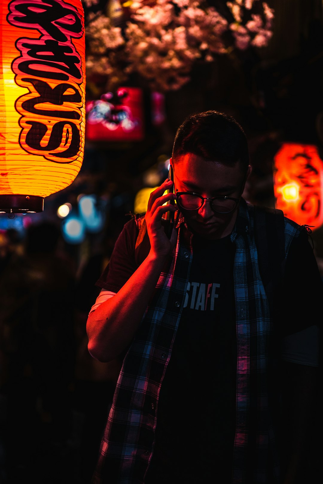 man using phone while standing during night time