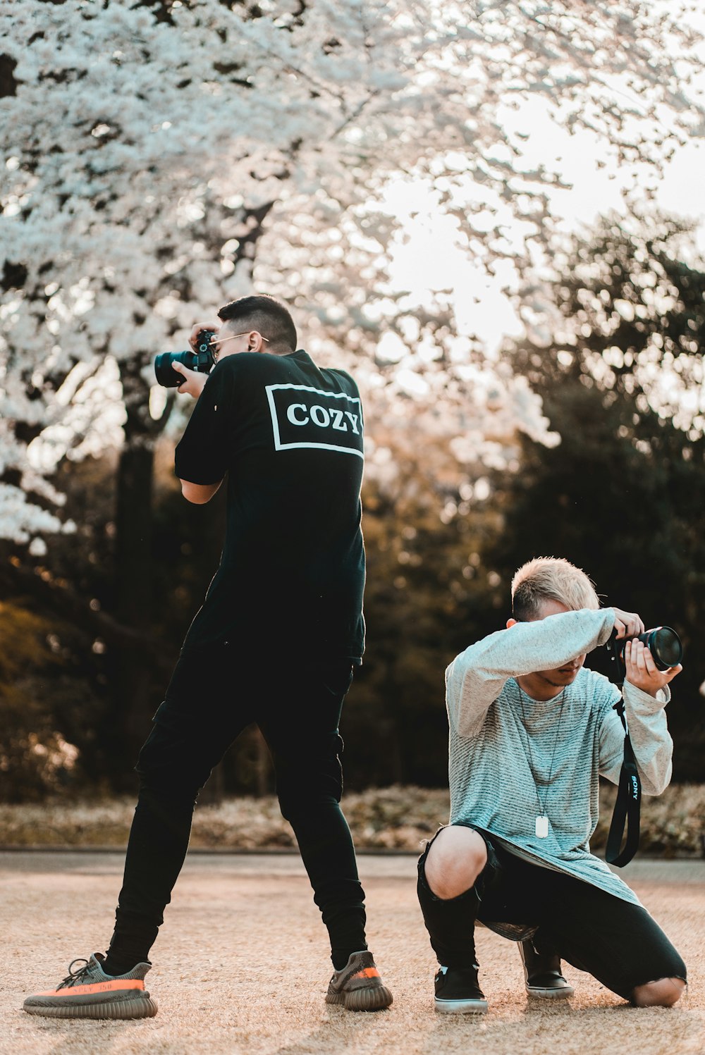 two men taking photos at daytime