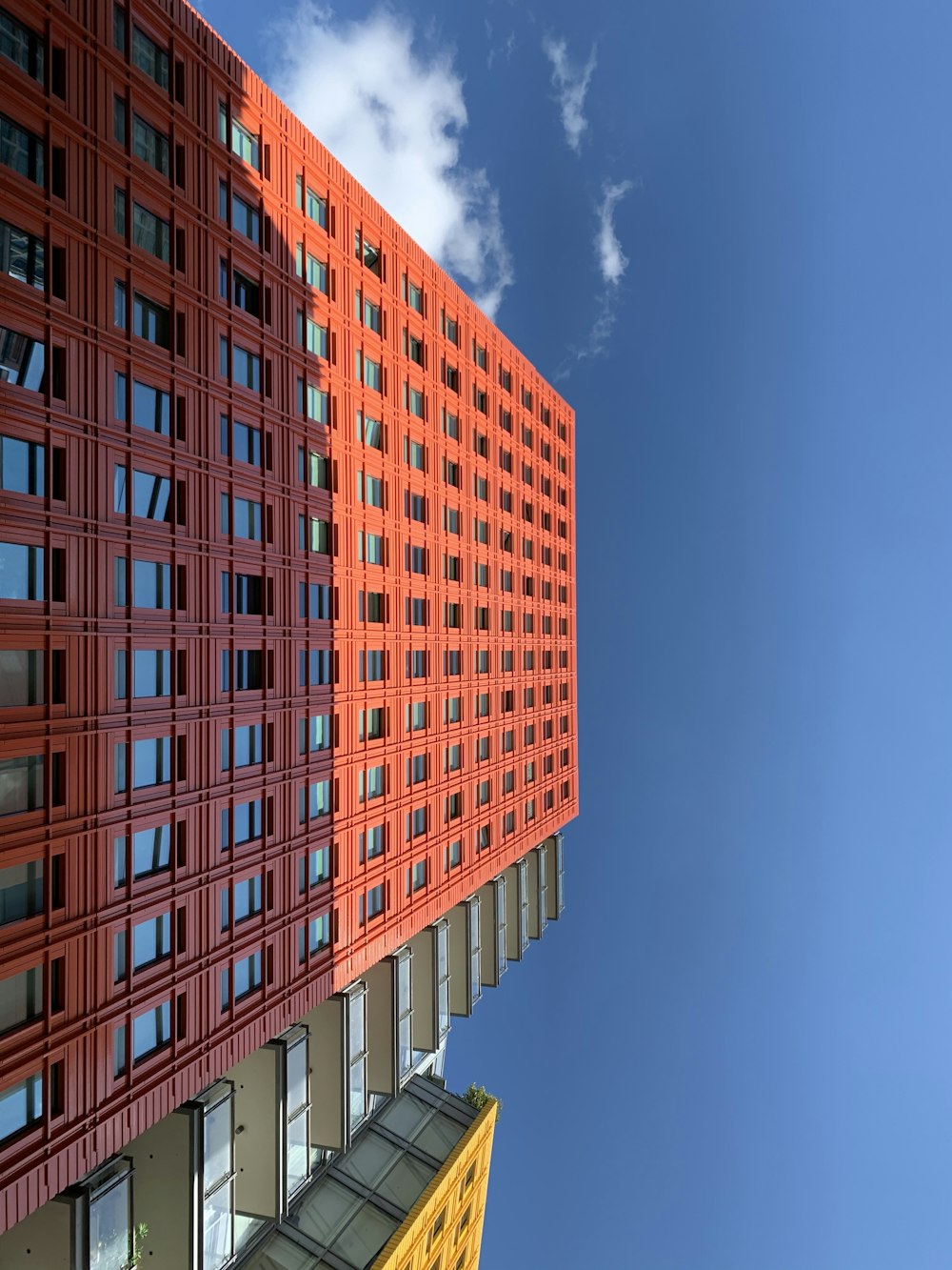 low-angle photography of red high-rise building