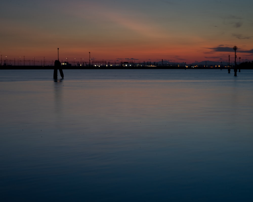 blue sea viewing city with high-rise buildings during night time