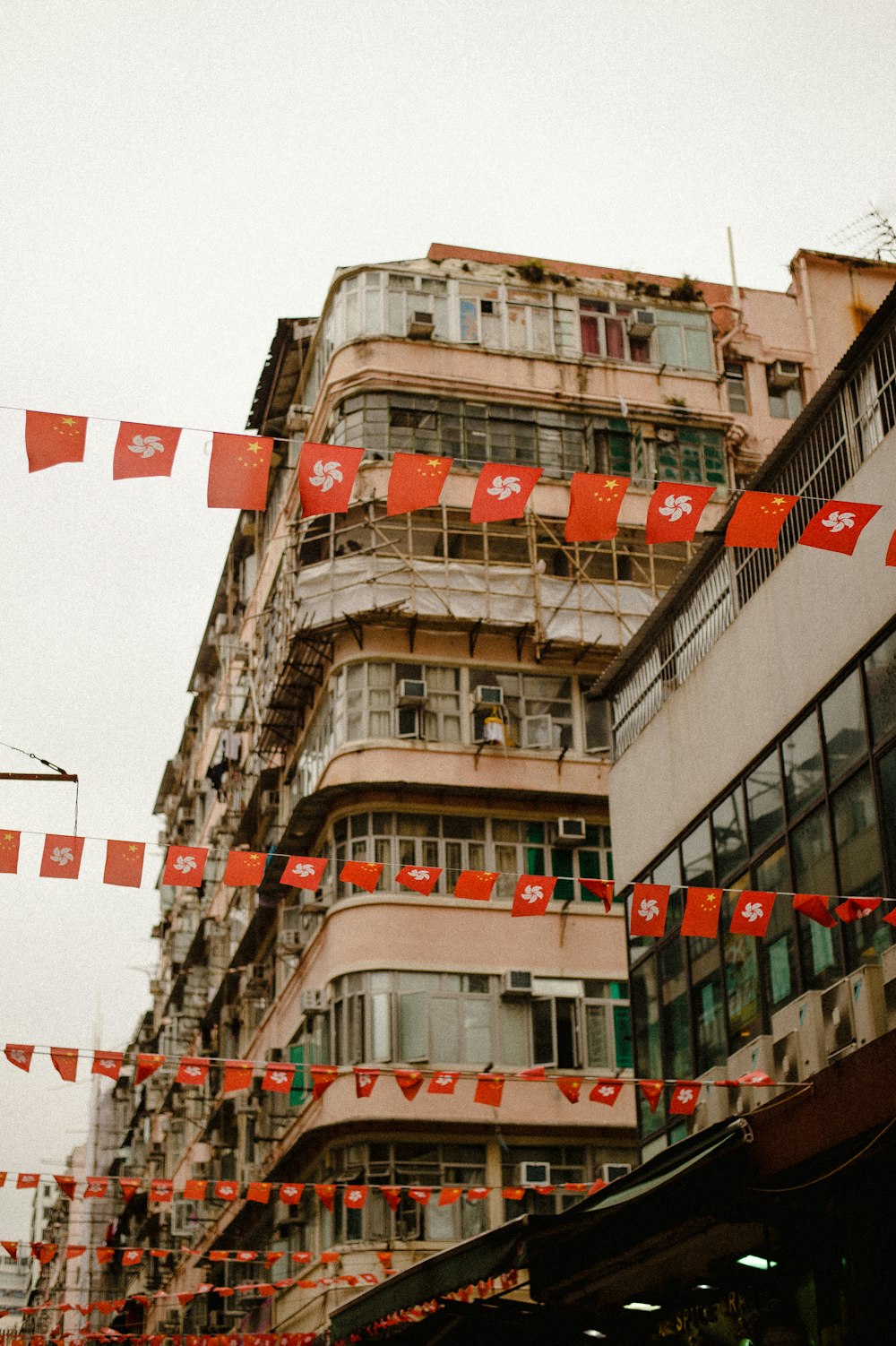 a building with red flags hanging from it's sides