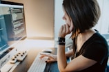 woman wearing black t-shirt holding white computer keyboard