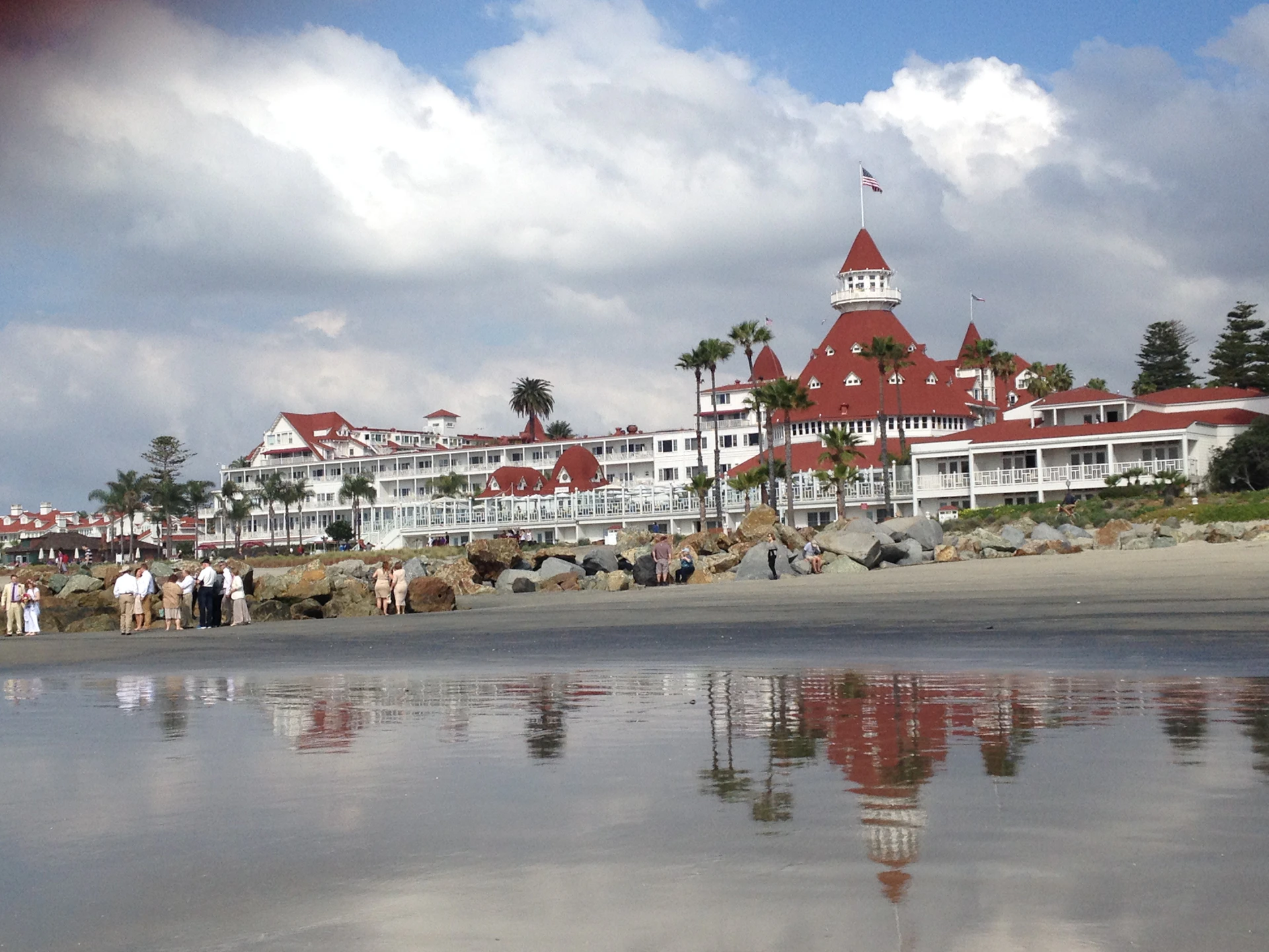 white and red concrete buildings near body of water