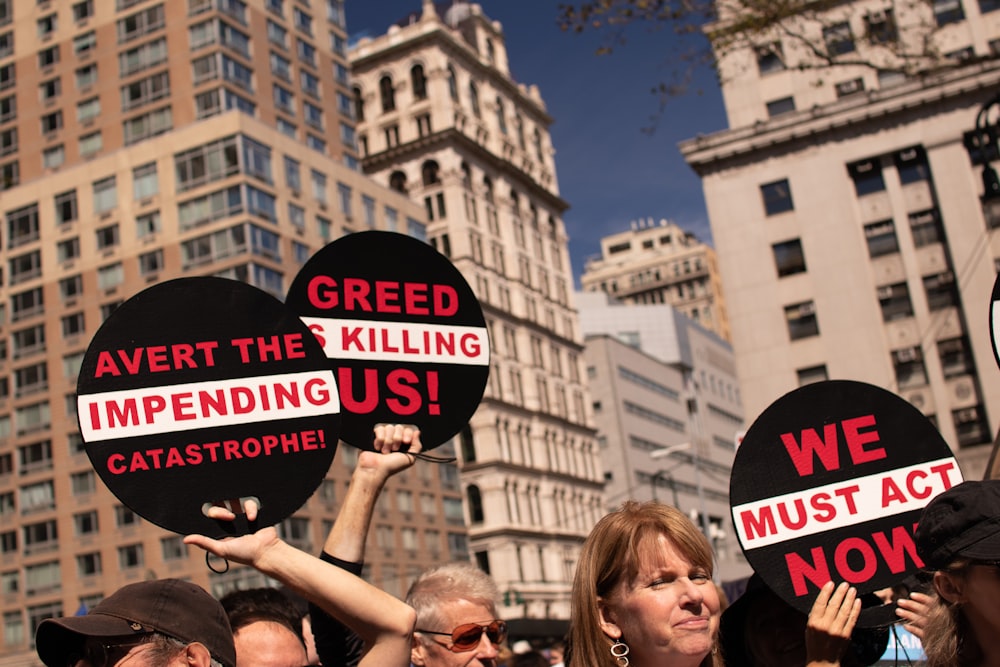 people raising signage near buildings