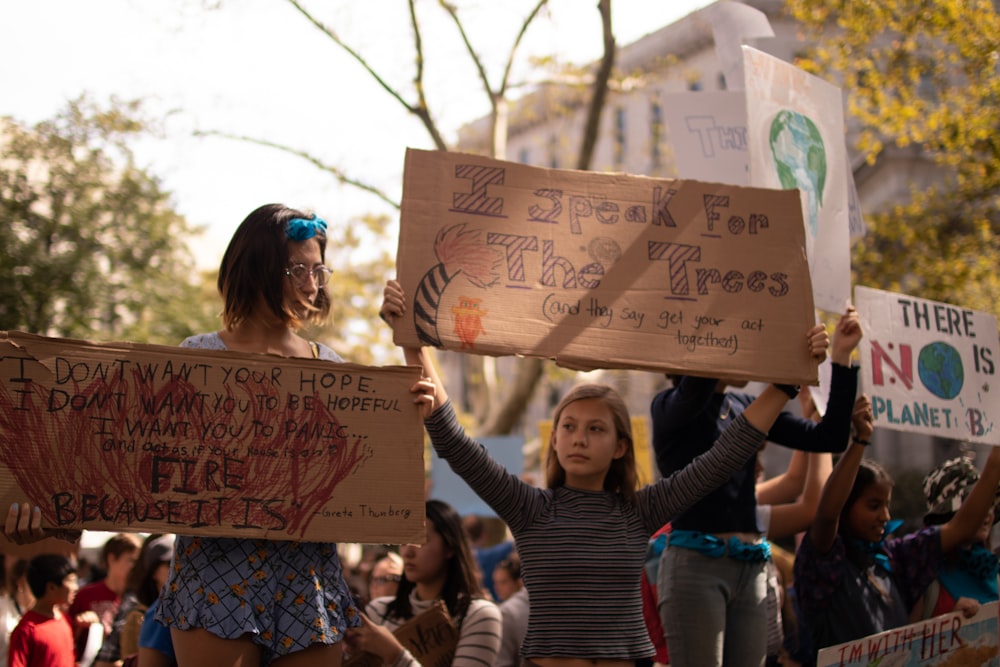 two women raising cardboard