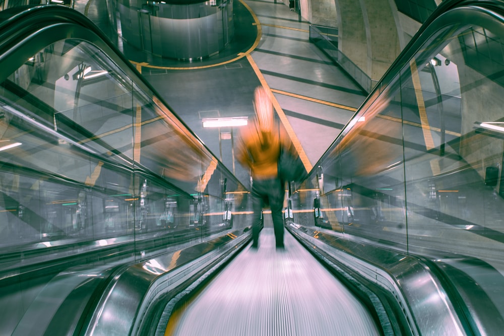 person standing on escalator