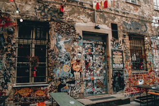 Graffiti art and rave flyers plastered on urban walls.