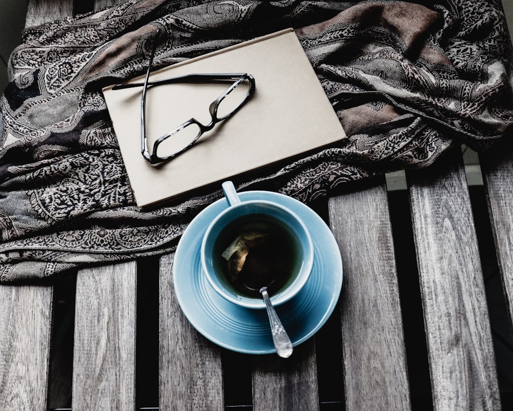 blue ceramic teacup with black liquid