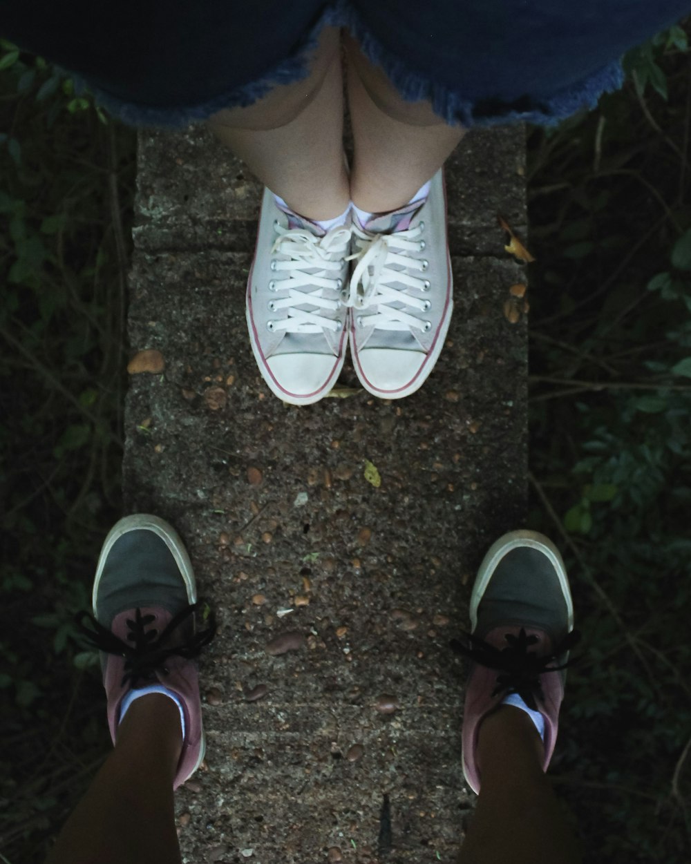 person wearing gray-and-white low-top sneakers