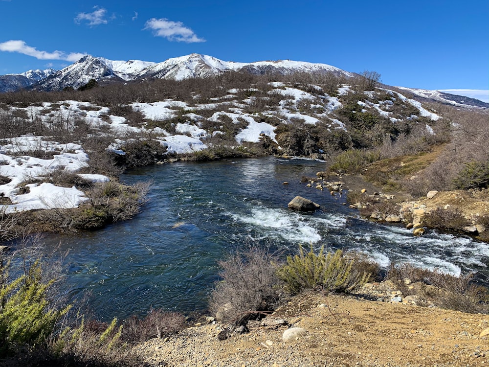 snow mountain and body of water