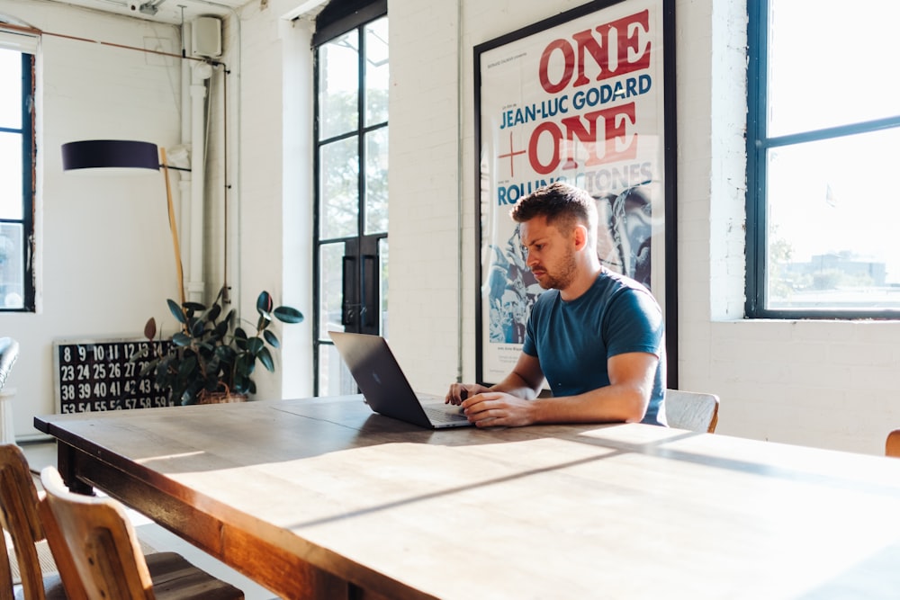 man sitting in front of MacBook Pro