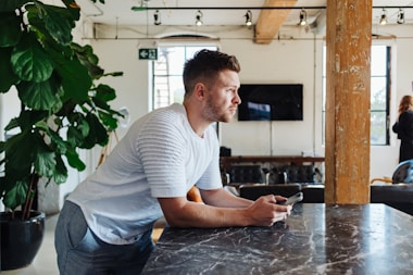man leaning on table