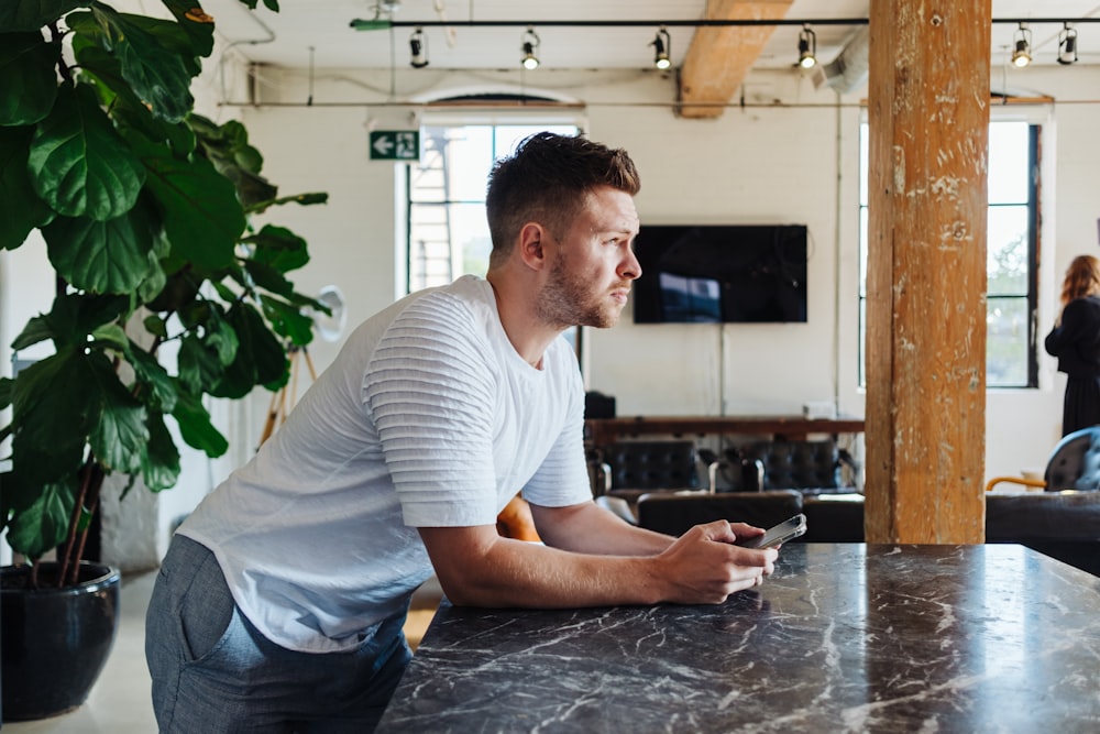 man leaning on table