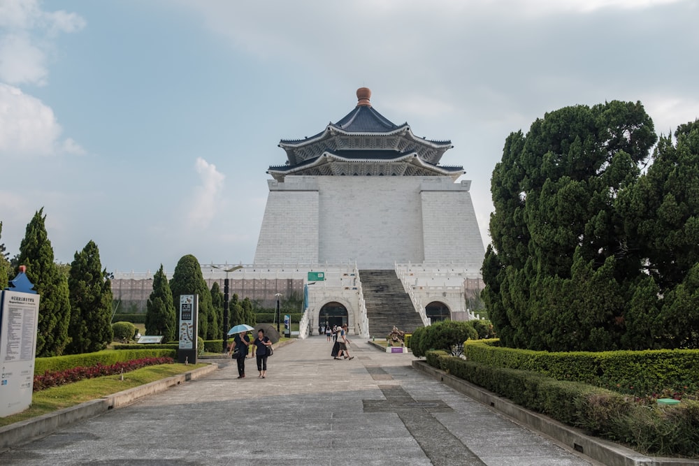 two women walking near cone top building