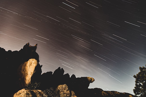 Wide-angle astrophotography capturing Milky Way stretching above the stone structures of Chaco Canyon.
