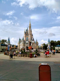 A scenic view of Disneyland's Sleeping Beauty Castle with guests strolling nearby.